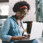 Smiling black student studying for a formative assessment on campus