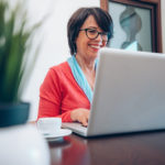 mature-woman-using-pc-laptop-indoor-VSLMU4X