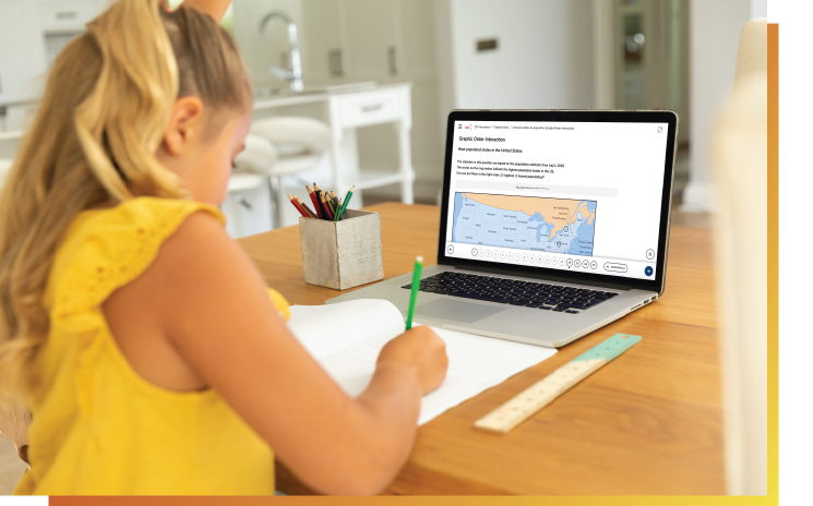 young girl in front of computer taking student assessment