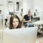 woman using computer in computer lab showing the use of higher education assessment tools in the classroom