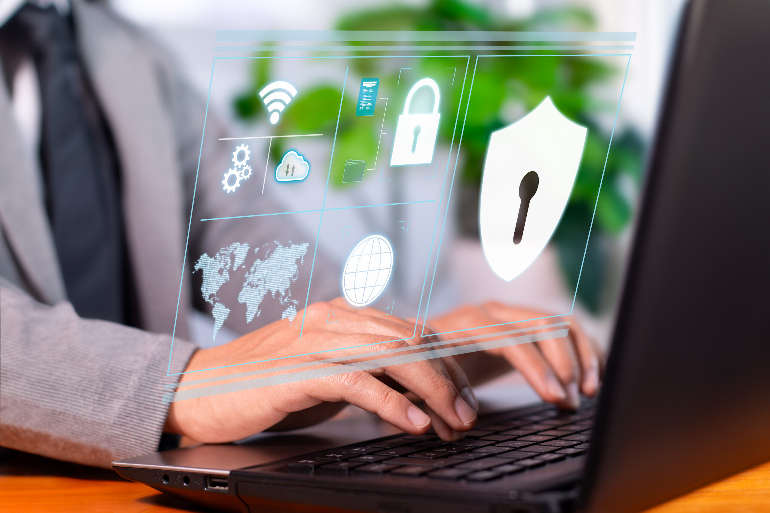 up close image of hands on keyboard with security symbols superimposed over the image, demonstratinng the concept of cybersecurity, secure assessment tools