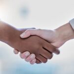 Business people, diversity and handshake in partnership, representing the partnership between TAO and Wiris MathType Math Editor