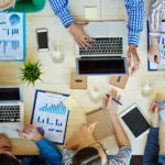 Featured image of working with computers to plan for rolling out an assessment platform